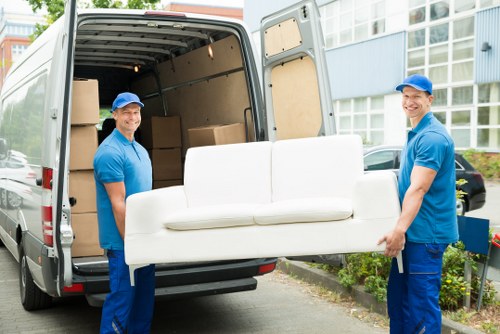 Removal van and moving team in Brixton street setting