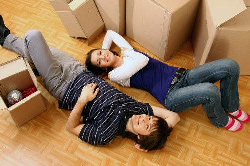 Local removals team handling furniture in a Brixton street